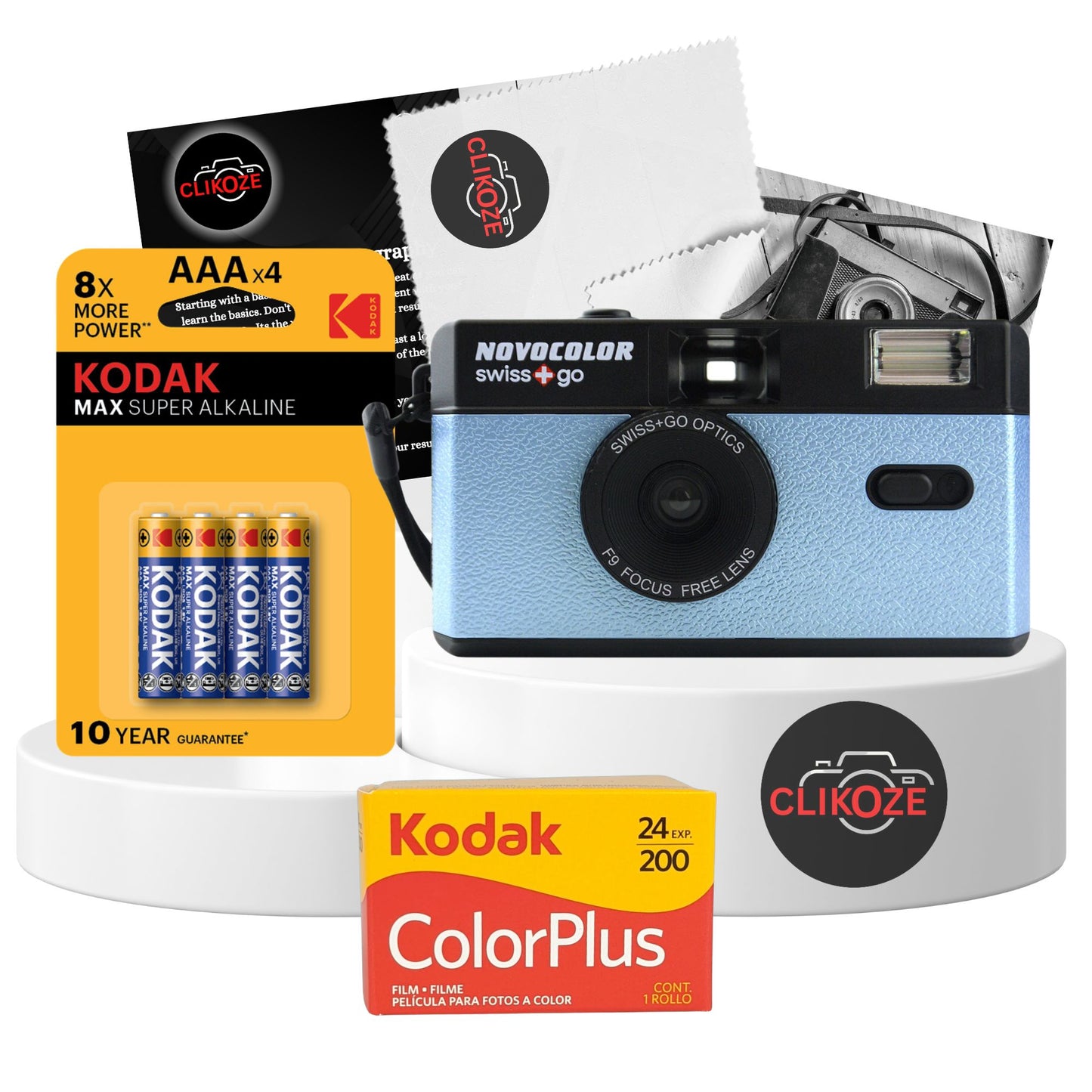 Blue Swiss+Go Novocolor reusable 35mm film camera with Kodak Colour Plus film, AAA battery, and photography tips card; perfect for capturing analog photos with built-in flash and wide-angle lens.